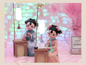 Close-up of vintage Chinese style girl figurines with glowing lanterns on pink background