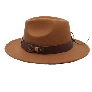 Brown wide brim cowboy hat with a bull head emblem and leather strap on white background