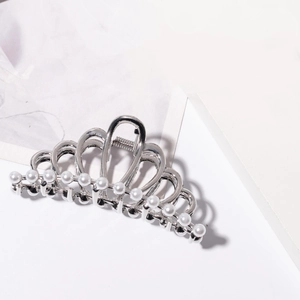 Close-up of crown hair claw clip with silver metal finish and small white pearls inlay