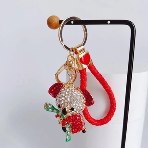 Detail of koala keychain with rhinestones, red braided leather rope and golden heart clasp