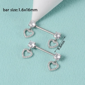 Macro view of silver heart-shaped nipple rings with zircon charms and sizing detail