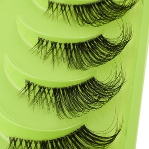 Macro shot of 10 pairs of black half-lashes with clear bands on a green tray