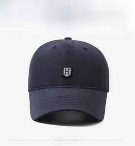 Close-up of navy blue baseball cap featuring breathable fabric and embroidered H logo