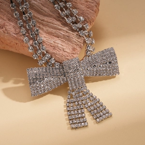Luxury silver-tone triple strand choker necklace featuring a sparkling crystal bow accent