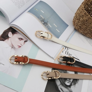 Macro detail of slim leather belts with gold buckles in black, brown, beige and white