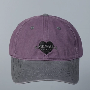 Detail of heart embroidery and vintage washed cotton texture on a baseball cap
