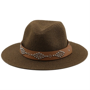 Detail of dark brown straw fedora featuring a leather band with silver metal rivets