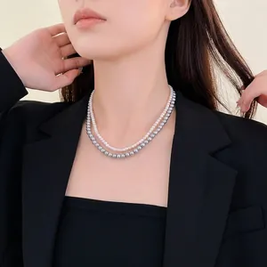 French style double-layer necklace with white and grey pearls on a model wearing black