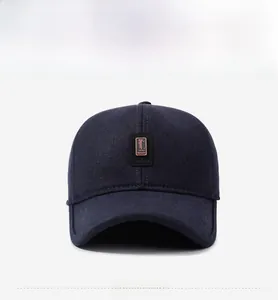 Detail of blue winter baseball cap with leather Golf Sport logo patch on front panel