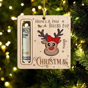 Detail of wooden reindeer ornament showing cash holder slot on a festive Christmas tree