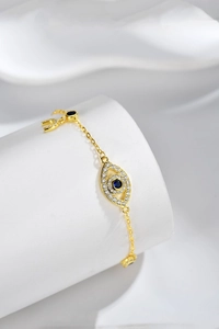 Detail of the golden S925 sterling silver evil eye bracelet with blue zircon inlay
