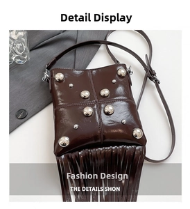 Detail view of dark brown leather crossbody bag with silver studs and long tassels