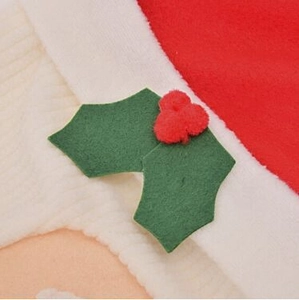 Close-up of Santa toilet cover detail featuring red fleece and holly berry ornaments