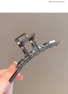 Macro shot of gunmetal shark hair clip featuring premium rhinestones and luxury finish