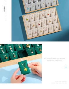Detail of bamboo jewelry tray with multi-compartment velvet inserts for necklaces