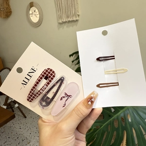 Detailed set of pink plaid bow hair clips and metal pins on display cards