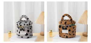Detail of plush leopard print makeup bags with gold zippers and Love Youth label