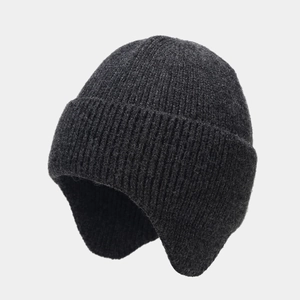Close-up of dark grey knitted beanie with vertical ribbed texture and ear protection