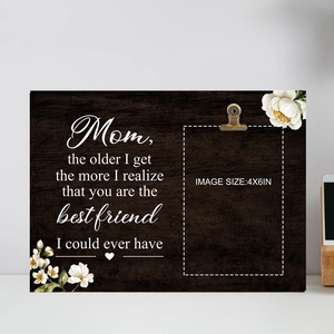 Detail of wooden Mother's Day photo frame with engraved quote and metal photo clip