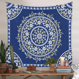 Deep blue bohemian mandala tapestry displayed on a wall with cozy home decor setting