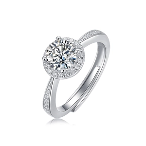 Macro detail of six-prong moissanite ring showing brilliant round cut and silver halo setting