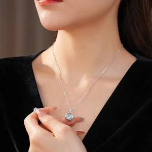 Detail of flower pendant featuring a blue zircon center surrounded by small crystals