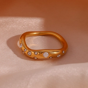 Detail of 18K gold plated stainless steel ring with micro-set irregular curved gems