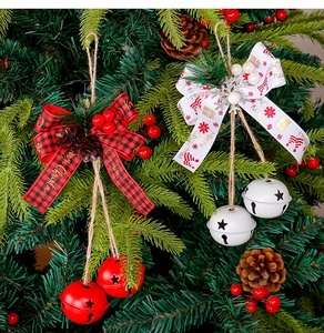 Christmas tree hanging ornament with red plaid bow and white bells on pine branches