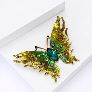 Luxury butterfly brooch with green yellow enamel and rhinestones on white background