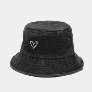 Close-up of heart embroidery and washed texture on vintage black cotton bucket hat