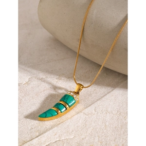 18k gold plated stainless steel necklace with green malachite pendant on stone surface