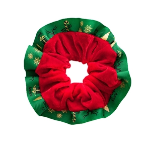 Christmas velvet scrunchie in red and green with festive gold Merry Xmas patterns