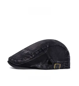 Detail of vintage grey washed denim flat cap with adjustable bronze metal side buckle