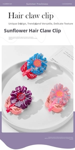 Macro detail of sunflower claw clips in sky blue, peach pink and deep purple acetate