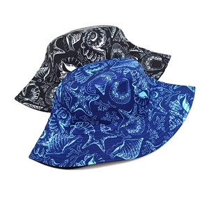 Detail view of summer bucket hats featuring nautical starfish and seashell prints