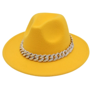 Close-up of bright yellow fedora hat featuring a chunky silver rhinestone chain band