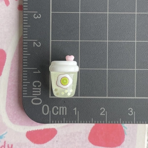 Detailed macro view of a 1.5cm mini resin kiwi fruit drink bottle charm for DIY crafts