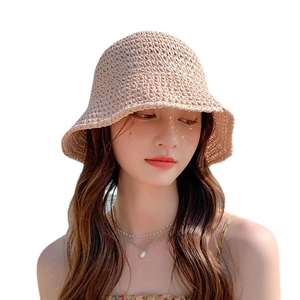 Minimalist hand-woven straw bucket hat in beige with breathable hollow sunshade texture