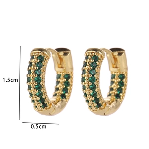 Macro view of gold hoop earrings with green zircon pave setting and 1.5cm height