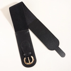 Detail of wide black elastic waist belt featuring a polished gold round metal buckle