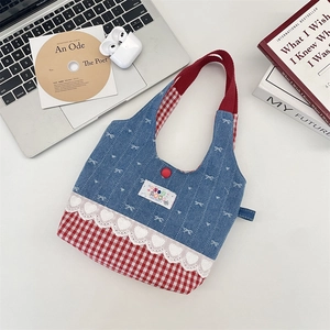Detail of sweet lace trim and contrast plaid stitching on denim bow tote bag