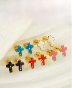 Detailed view of colorful enamel cross stud earrings with gold plating in various colors