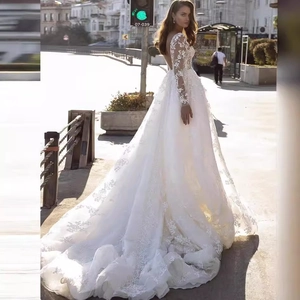 Elegant white lace long sleeve wedding dress with V-neck back and long cathedral train