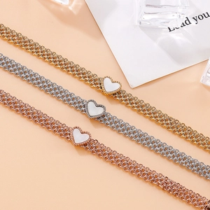Three-color multi-layer heart charm bracelet in gold, silver, and rose gold finish