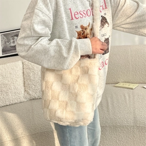 Close-up of plush checkerboard shoulder bag in soft faux rabbit fur on model
