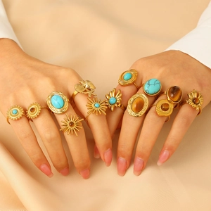 Close-up of bohemian style turquoise and tiger eye rings on a model's hands