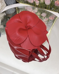 Close-up of red flower petal tote bag featuring 3D PU leather design and pearl stamen details