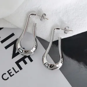 Minimalist silver U-shaped teardrop earrings with a high-polished metallic finish