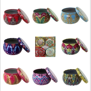 Detail view of 12 colorful bohemian mandala metal candle tins with scented candle gift box