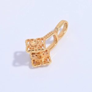 Detailed view of the gold four-leaf clover clasp with intricate hollowed petal design
